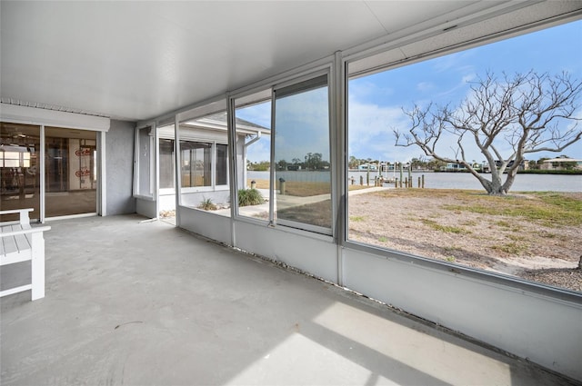 unfurnished sunroom with a water view