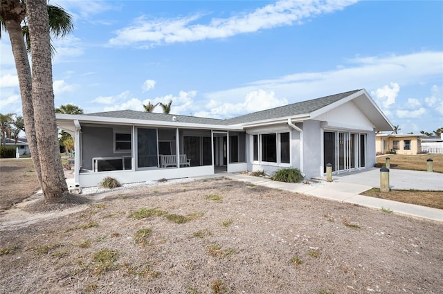 rear view of house with a sunroom