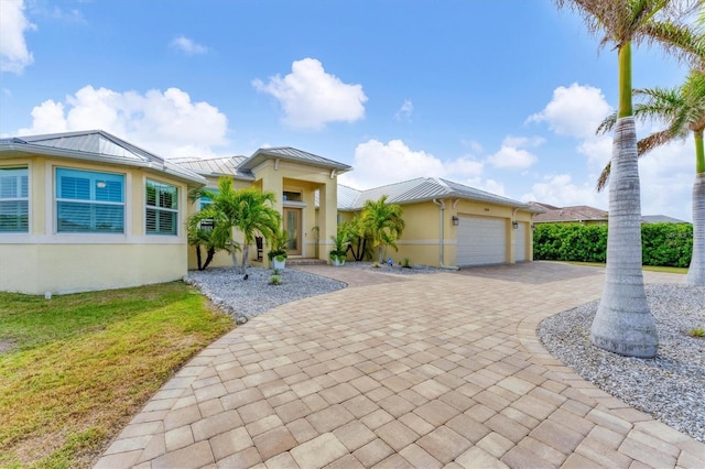 view of front of home with a garage and a front lawn