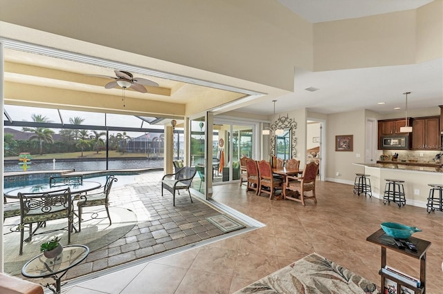 interior space with ceiling fan and a water view