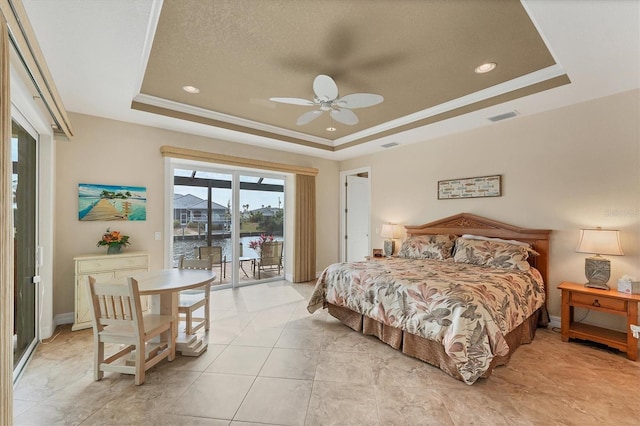 tiled bedroom with ceiling fan, a raised ceiling, ornamental molding, and access to outside