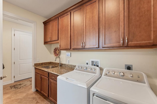 laundry area with sink, cabinets, and washer and dryer