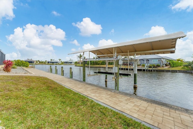 view of dock featuring a lawn and a water view