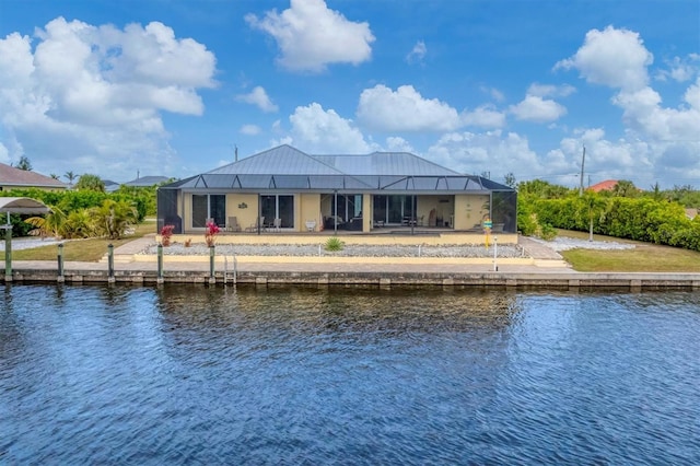 back of house with glass enclosure and a water view