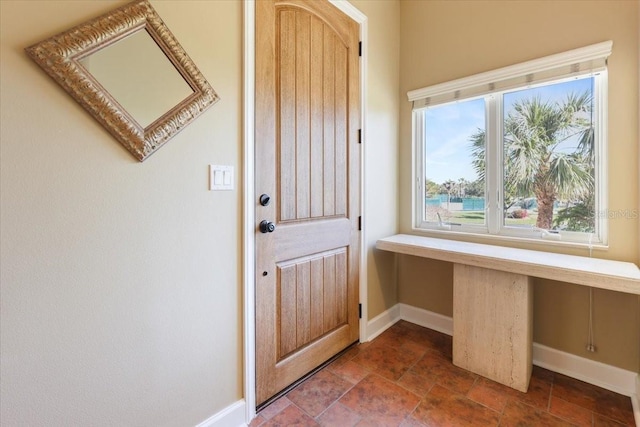 doorway to outside featuring built in desk