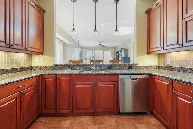 kitchen with pendant lighting, tasteful backsplash, dishwasher, sink, and dark stone countertops