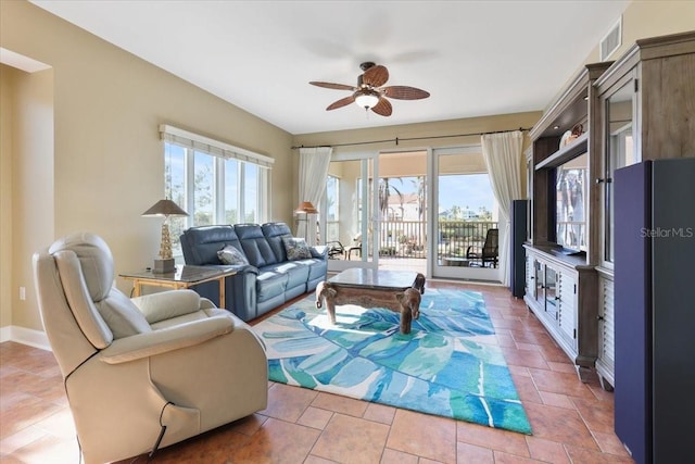 living room featuring ceiling fan and tile patterned floors