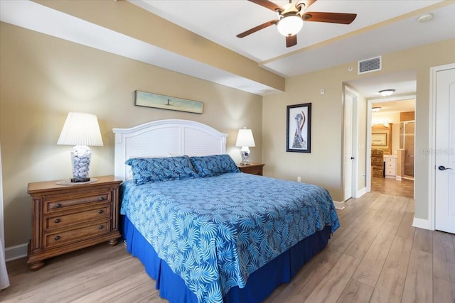 bedroom featuring light wood-type flooring, connected bathroom, and ceiling fan