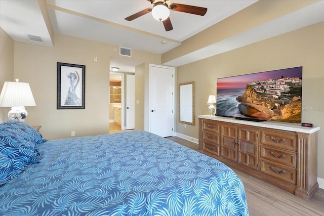 bedroom with ensuite bath, ceiling fan, and light wood-type flooring