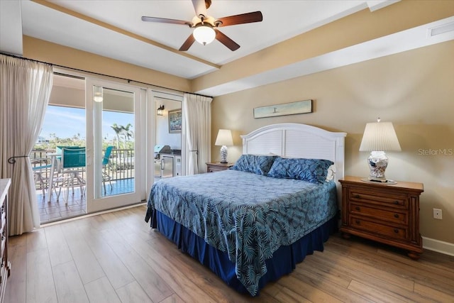 bedroom with hardwood / wood-style floors, access to outside, and ceiling fan