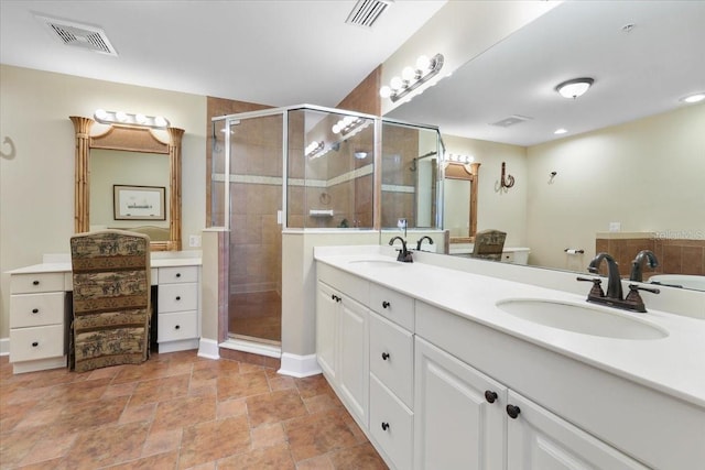 bathroom featuring vanity, toilet, and a shower with door