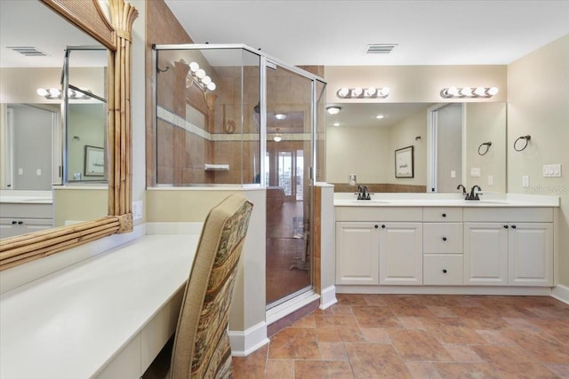 bathroom with vanity and a shower with door