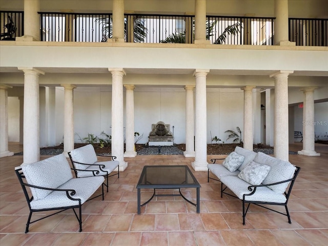 view of patio / terrace with a balcony and an outdoor fire pit