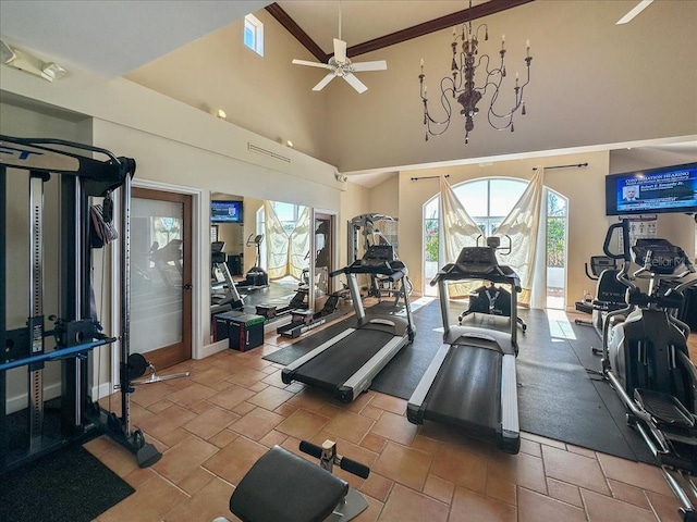 exercise room with a high ceiling and ceiling fan