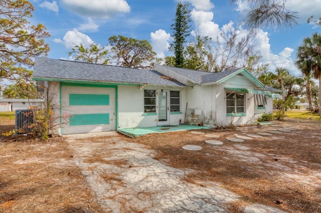 back of house featuring a garage