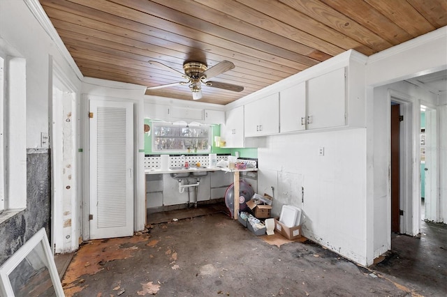 kitchen with ceiling fan, ornamental molding, wood ceiling, and white cabinets