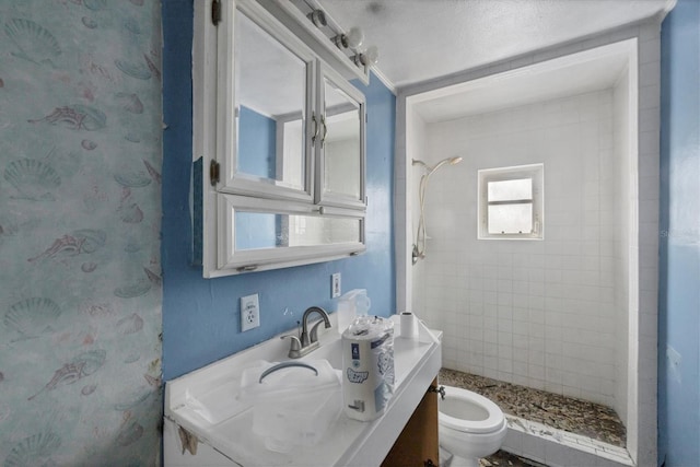 bathroom featuring toilet and tiled shower