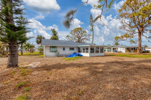 back of property featuring a sunroom