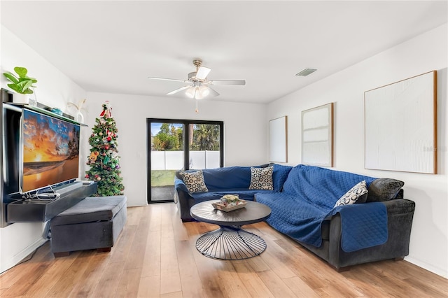 living room featuring ceiling fan and light wood-type flooring