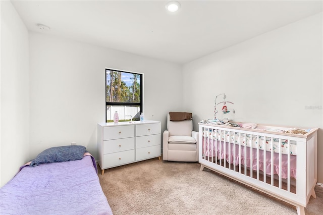 bedroom featuring light colored carpet