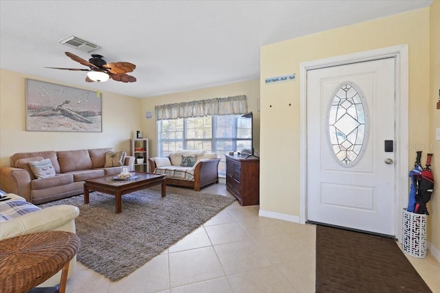 tiled foyer with ceiling fan