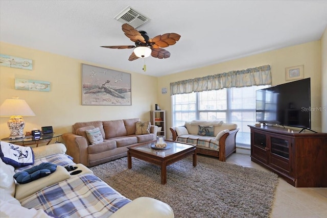 living room featuring light tile patterned flooring and ceiling fan