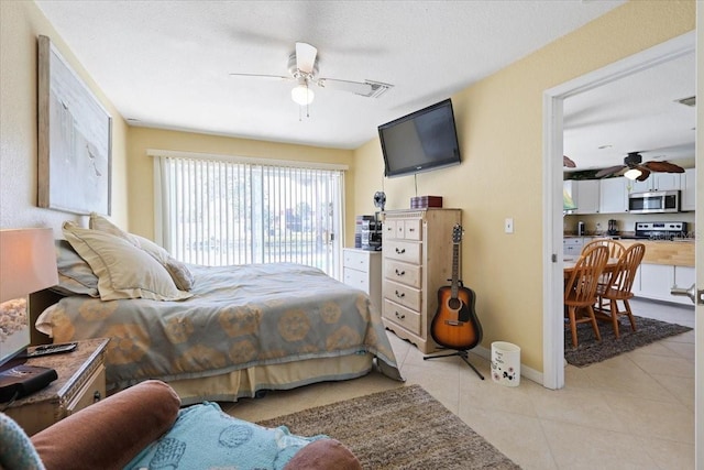 tiled bedroom featuring ceiling fan and a textured ceiling