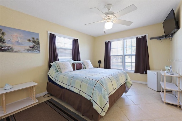 bedroom featuring light tile patterned floors and ceiling fan