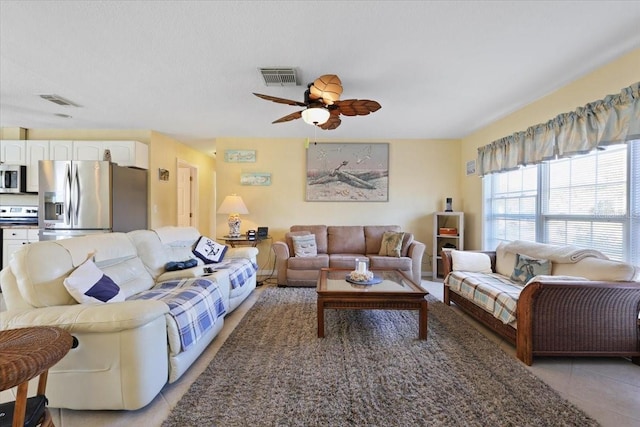 tiled living room featuring ceiling fan