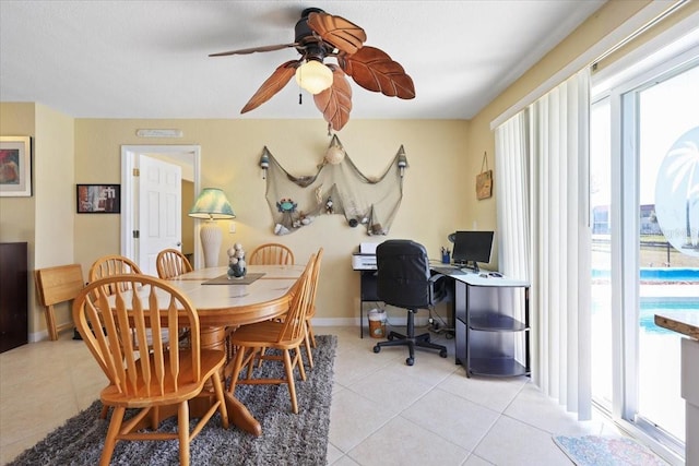 tiled dining space featuring ceiling fan