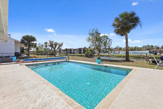 view of pool featuring a patio and a water view