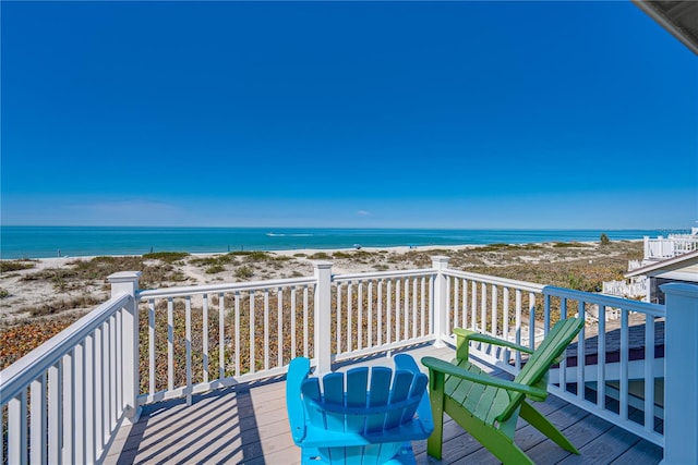 balcony featuring a water view and a view of the beach