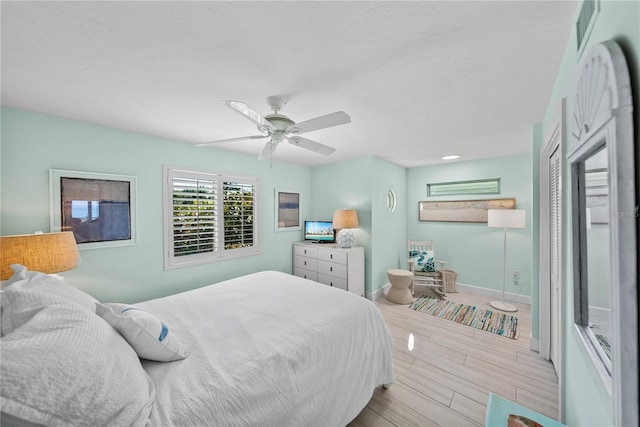 bedroom with ceiling fan and a closet