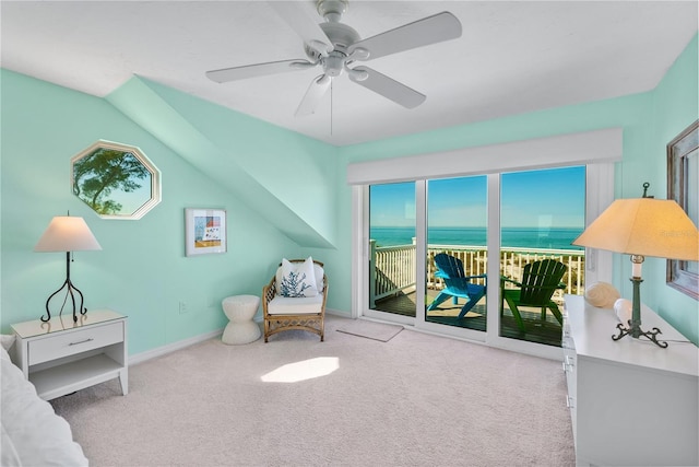 sitting room with light carpet, lofted ceiling, ceiling fan, and a water view