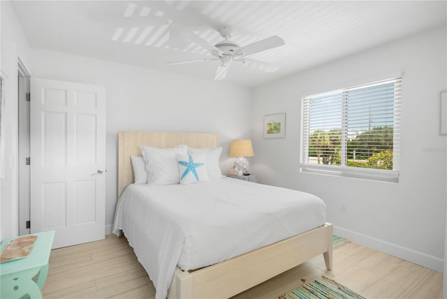 bedroom with ceiling fan and light hardwood / wood-style floors