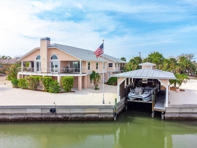 rear view of house featuring a water view