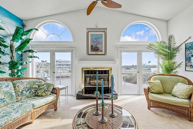 carpeted living room featuring high vaulted ceiling, french doors, and ceiling fan