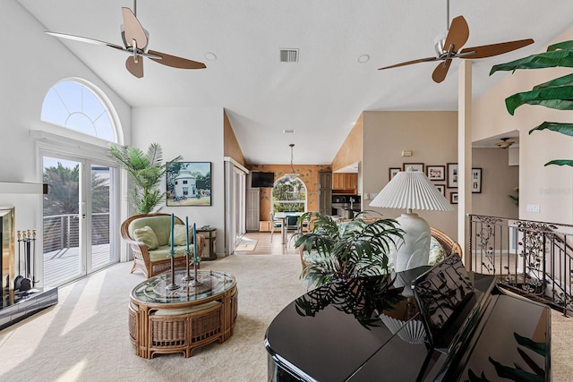 living room featuring ceiling fan, light colored carpet, high vaulted ceiling, and french doors