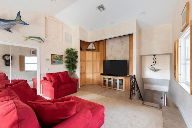 tiled living room with vaulted ceiling