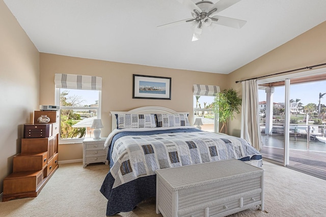 carpeted bedroom featuring lofted ceiling, access to exterior, and ceiling fan