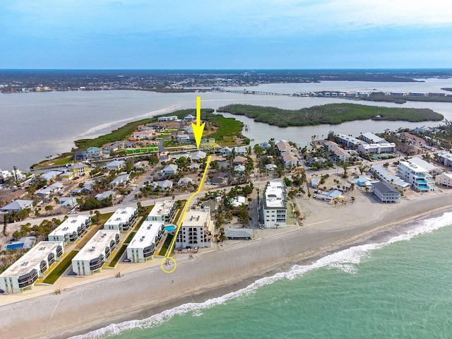 aerial view featuring a water view and a beach view