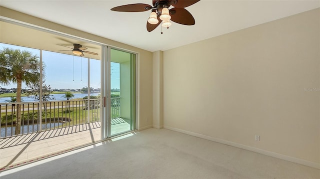 carpeted spare room featuring a water view