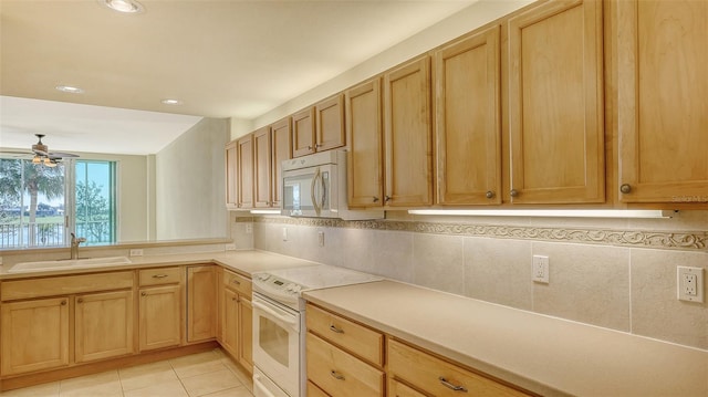 kitchen with light tile patterned flooring, sink, decorative backsplash, ceiling fan, and white appliances