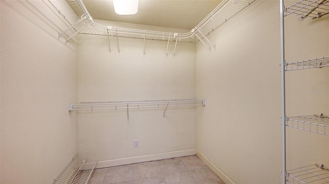 spacious closet featuring light tile patterned floors