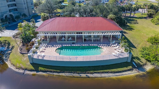 view of pool with a patio area and a water view