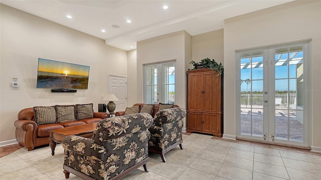 living room featuring light tile patterned floors, a wealth of natural light, and french doors