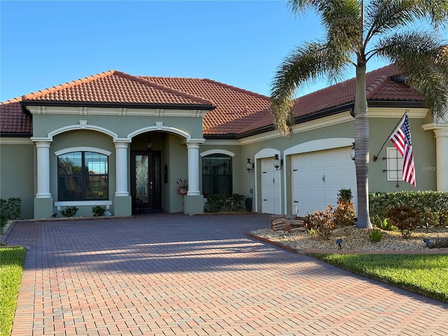 mediterranean / spanish-style home with a garage