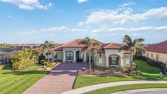 mediterranean / spanish-style house with a front yard