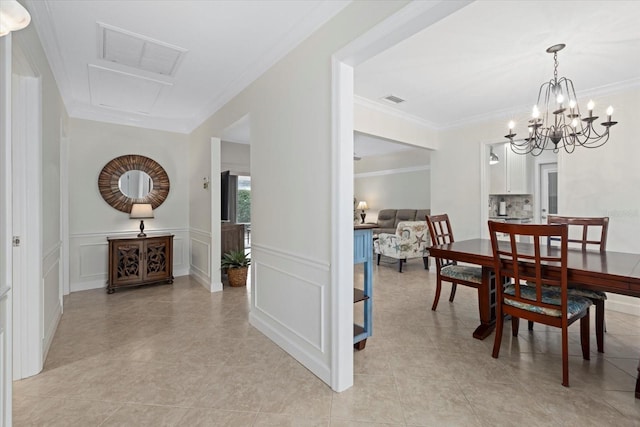 dining space featuring a notable chandelier, crown molding, and light tile patterned flooring