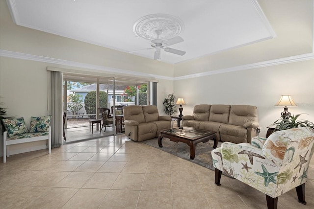 tiled living room featuring ornamental molding, ceiling fan, and a tray ceiling